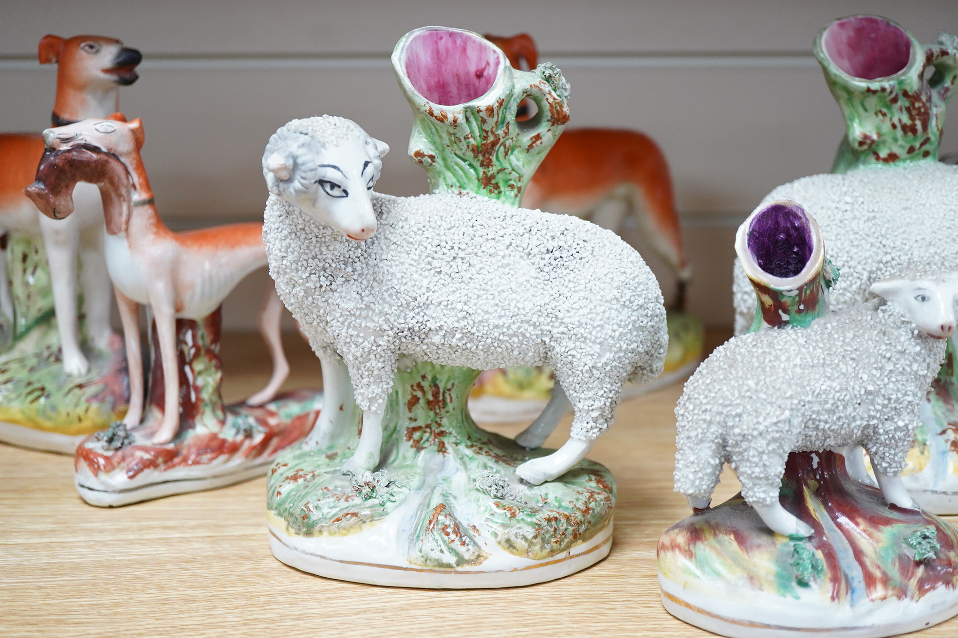 Two pairs of Victorian Staffordshire zebra models and others to include three sheep spill vases, largest 19cm high